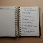 Open planner with New Year's resolutions, spiral binding, and pen on warm-toned background.